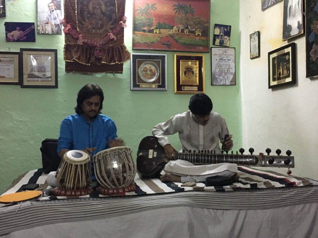 Two men playing traditional Indian instruments