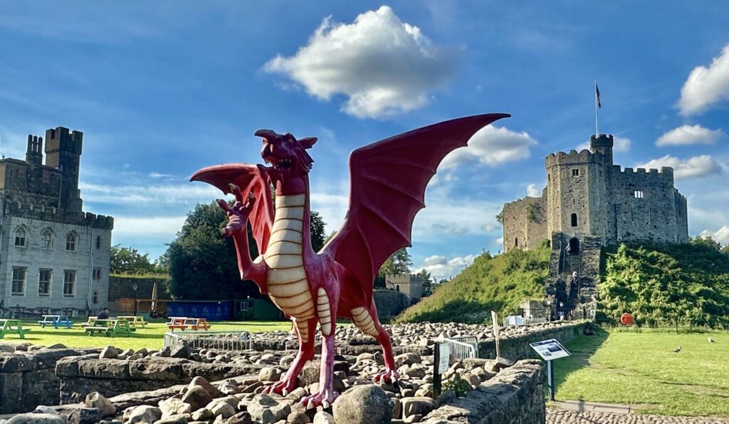 The trademark red dragon of Wales poses in front of the Cardiff Caste Keep on a lovely sunny day (above). @BarbaraRedding