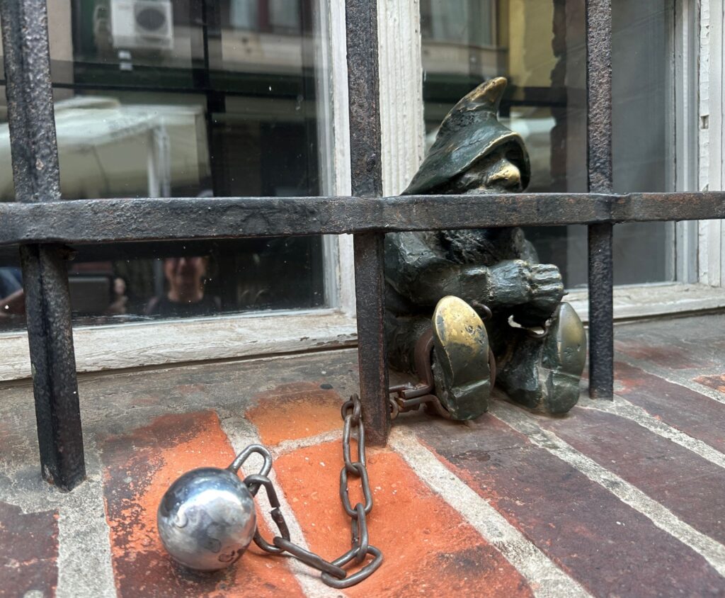 An imprisoned dwarf outside the old jail in Wroclaw.