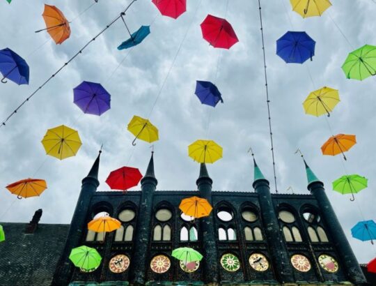 Colorful umbrellas flying over Lübeck's old Town Hall. @Barbara Redding