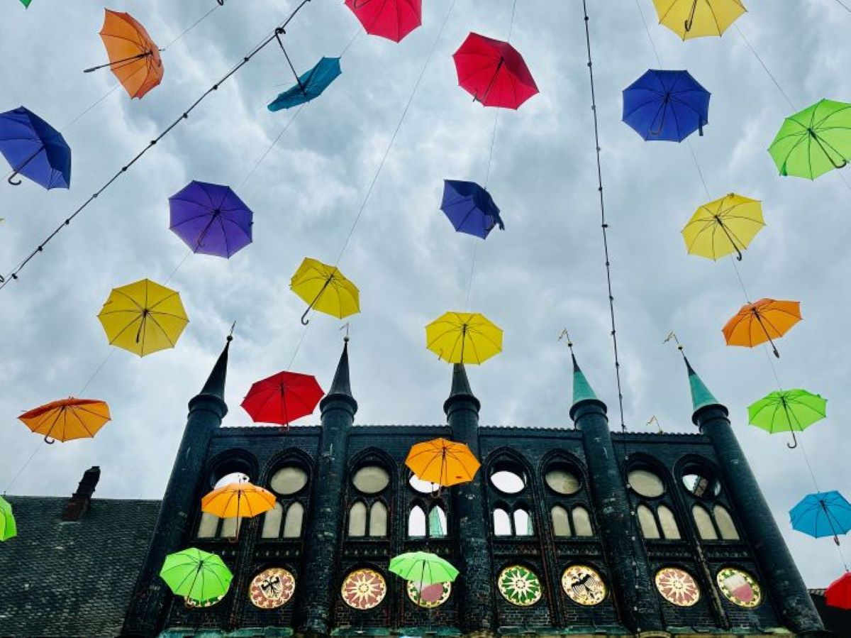 Colorful umbrellas flying over Lübeck's old Town Hall. @Barbara Redding