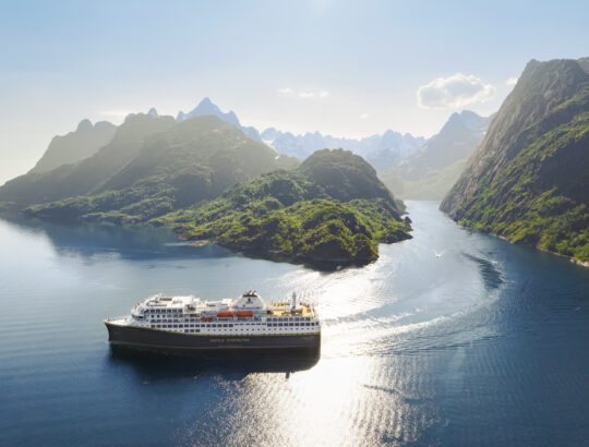 A Havila Voyages cruise ship sailing in Trolljorden along the Norwegian Coast.