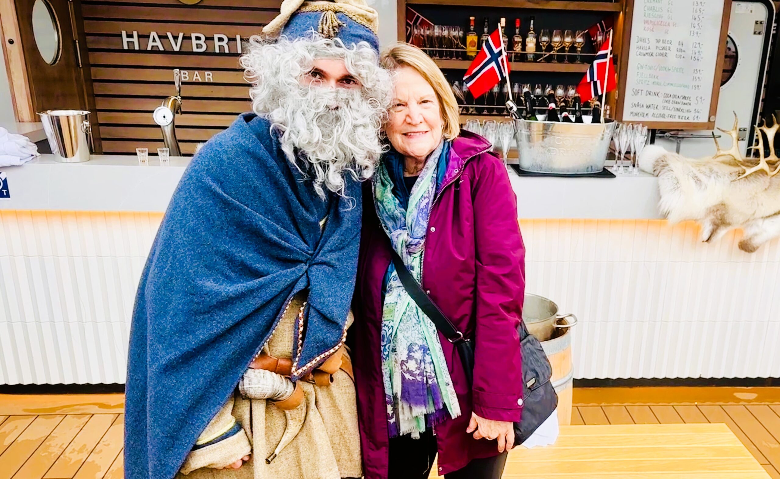 Author gets a hug from the Norse God of the Sea on a Norway fjord cruise. Photo by Linda Redding