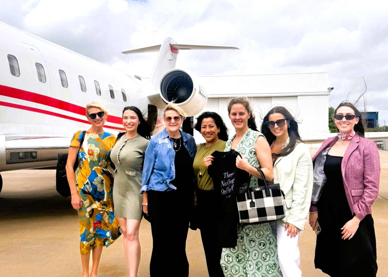 Travel writers in front of a Cirrus jet as part of a trip to Dallas to experience the FIFA World Cup 2026 soccer games in Dallas.
